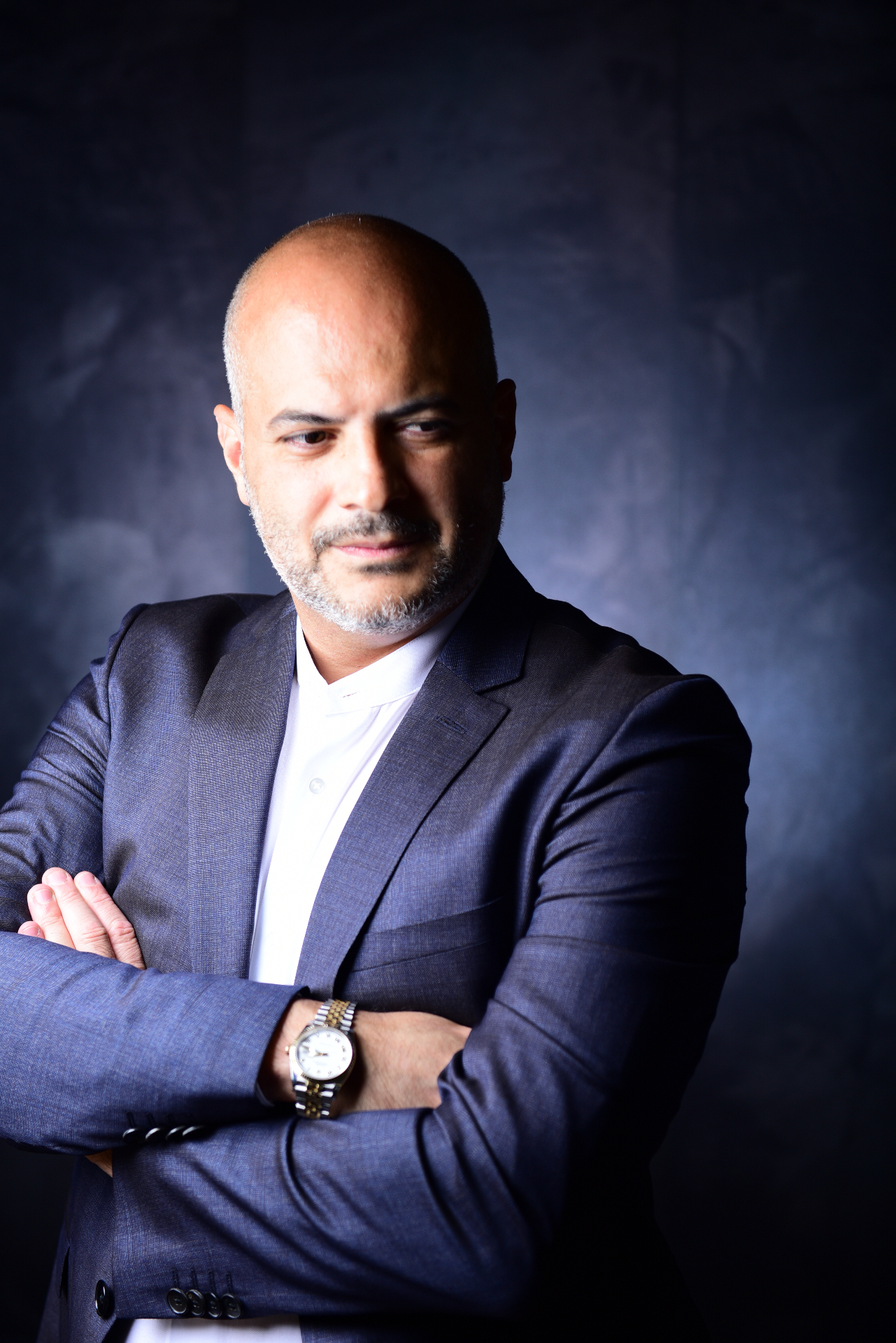 Gaston Rivero in a formal dark suit portrait