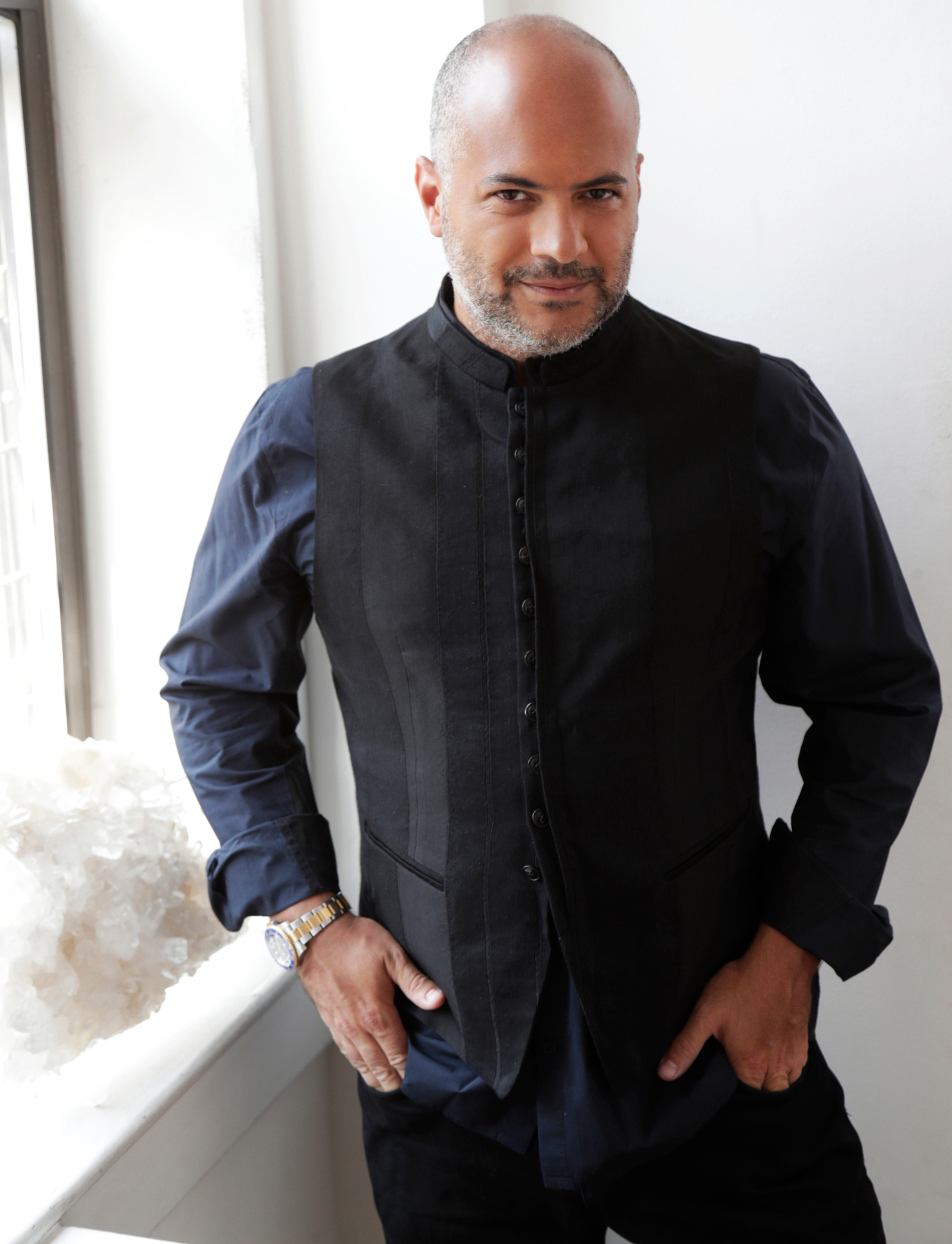 Gaston Rivero by the window in black attire